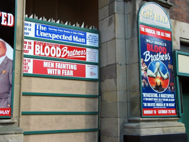 Men Fainting with Fear on hoardings at the Grand Theatre